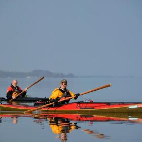 two people sailing a kayak
